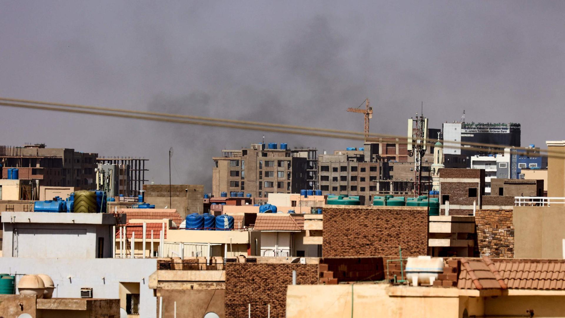 Fogo perto de edifícios residenciais proveniente dos confrontos militares, na capital sudanesa Cartum.