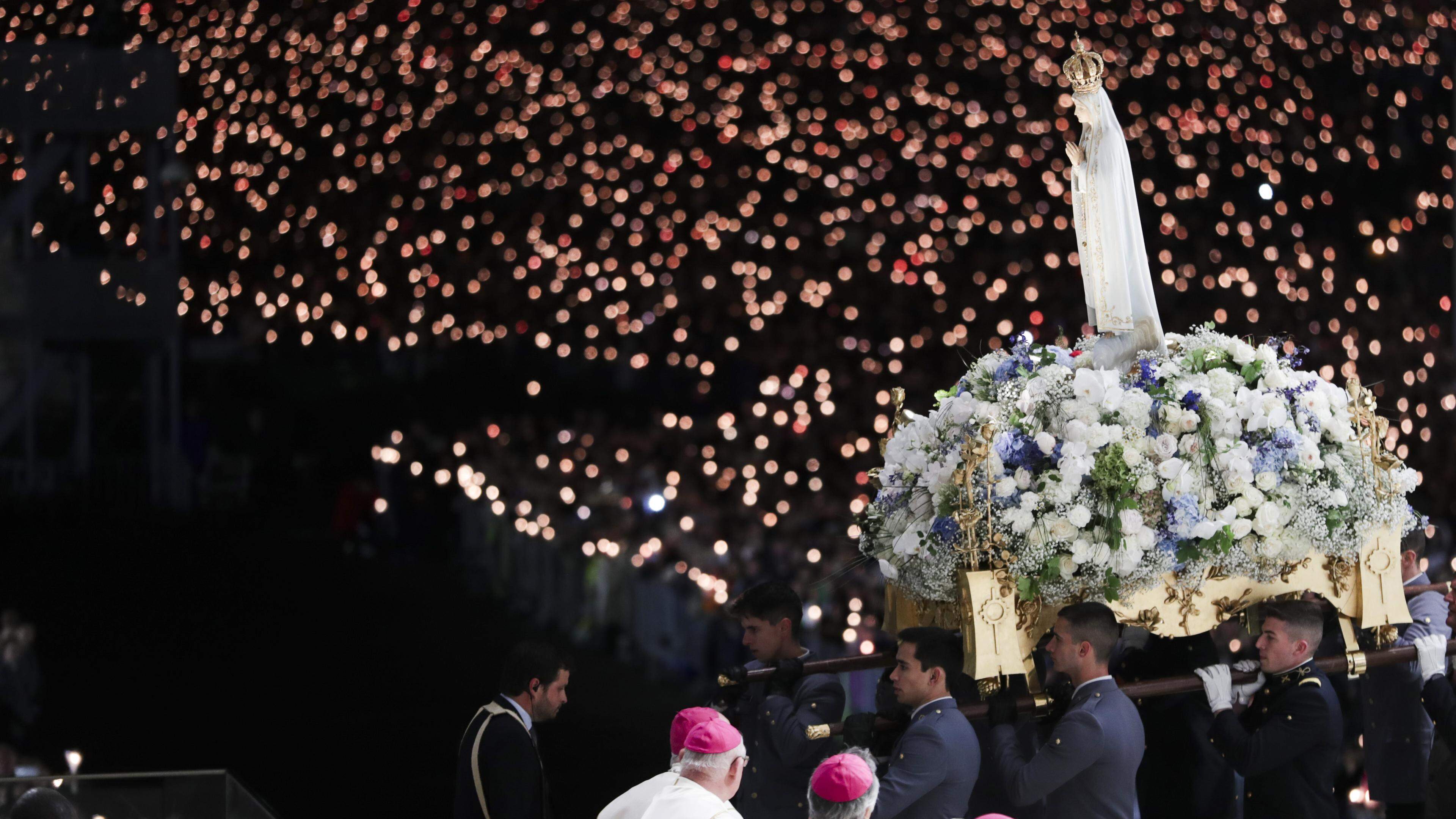 The image of Our Lady of Fatima is transported during the candle lights procession of the 13th May pilgrimage at the Shrine of Fatima, Portugal, 12 May 2024. PAULO CUNHA/LUSA