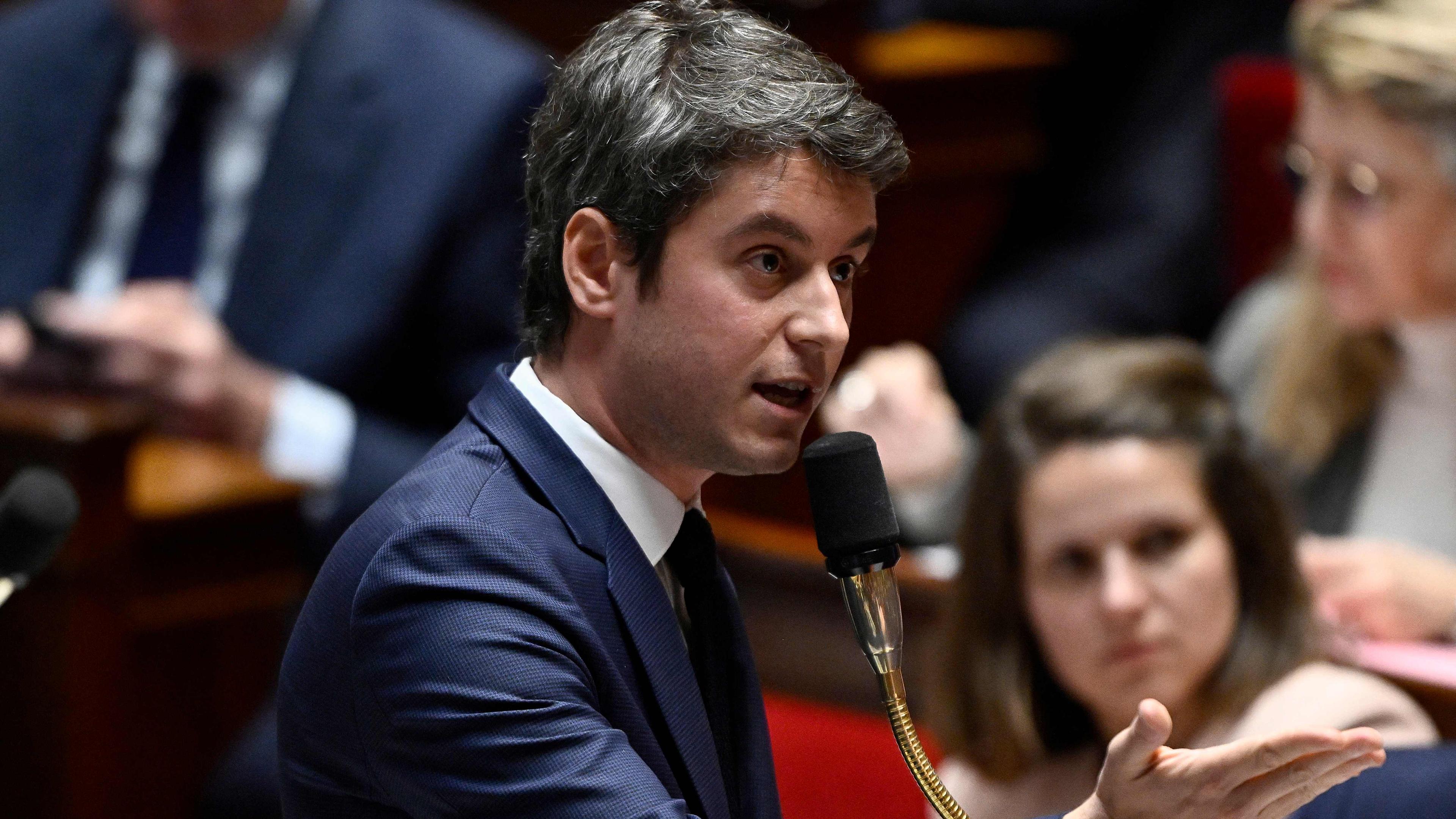 France's Prime Minister Gabriel Attal (R) speaks during a session of questions to the government at The National Assembly in Paris on March 26, 2024. (Photo by JULIEN DE ROSA / AFP)