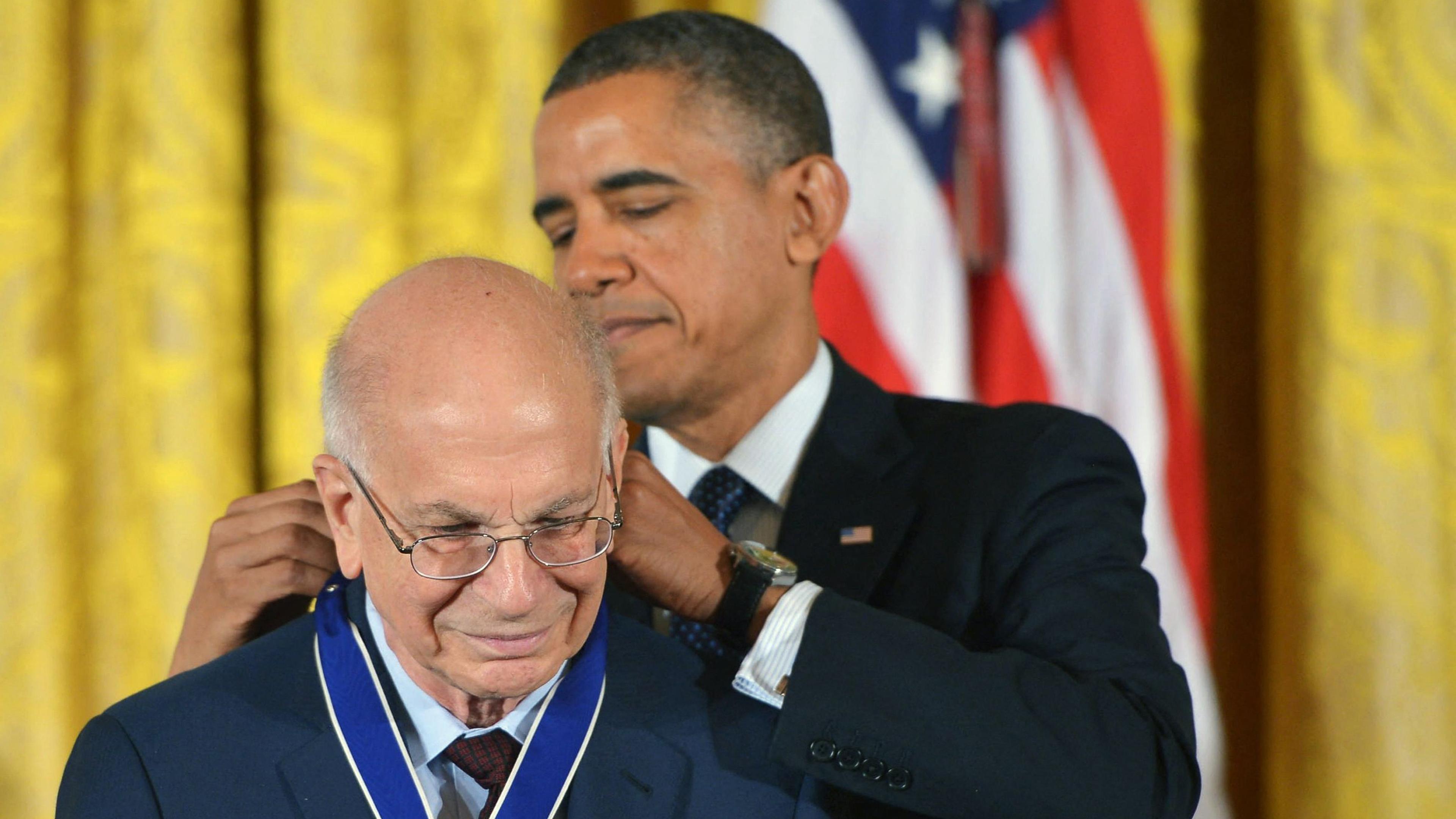 (FILES) US President Barack Obama presents the Presidential Medal of Freedom to psychologist Daniel Kahneman during a ceremony in the East Room of the White House on November 20, 2013 in Washington, DC. Nobel Prize winner Daniel Kahneman, who pioneered theories in behavioral economics that heavily influenced the discipline, has died at age 90, his employer confirmed March 27.
Kahneman, who wrote best-selling book "Thinking, Fast and Slow," argued against the notion that people's behavior is rooted in a rational decision-making process -- rather that it is often based on instinct. (Photo by Mandel NGAN / AFP)