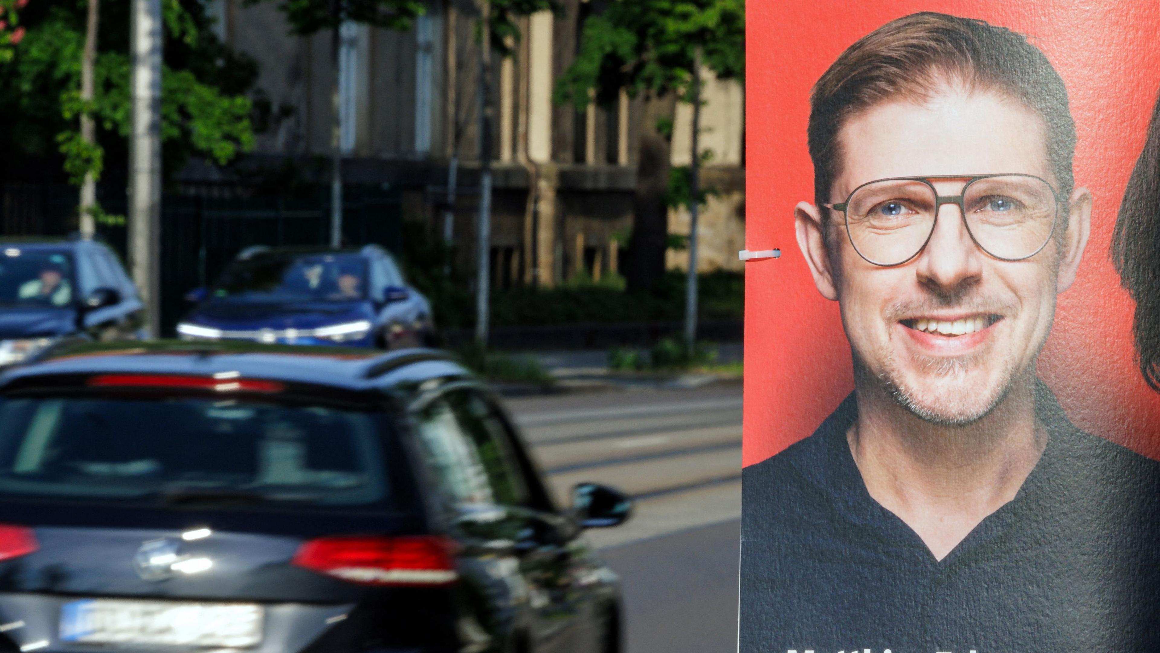 An election poster showing Germany's Social Democratic Party SPD lead candidate Matthias Ecke for the upcoming European Parliament elections is seen attached to a lamp post along Schandauer Strasse in the city district of Striesen in Dresden, eastern Germany on May 4, 2024. German Chancellor Scholz on May 4 condemned an attack on one of his party's European Parliament deputies as a "threat" to democracy after authorities said a political motive was suspected. Police said four unknown attackers beat up Matthias Ecke, an MEP for the Social Democratic Party (SPD), as he put up EU election posters in the eastern city of Dresden on Friday night, May 3. Ecke, 41, was "seriously injured" and required an operation after the attack, his party said. Police confirmed he needed hospital treatment. (Photo by JENS SCHLUETER / AFP)