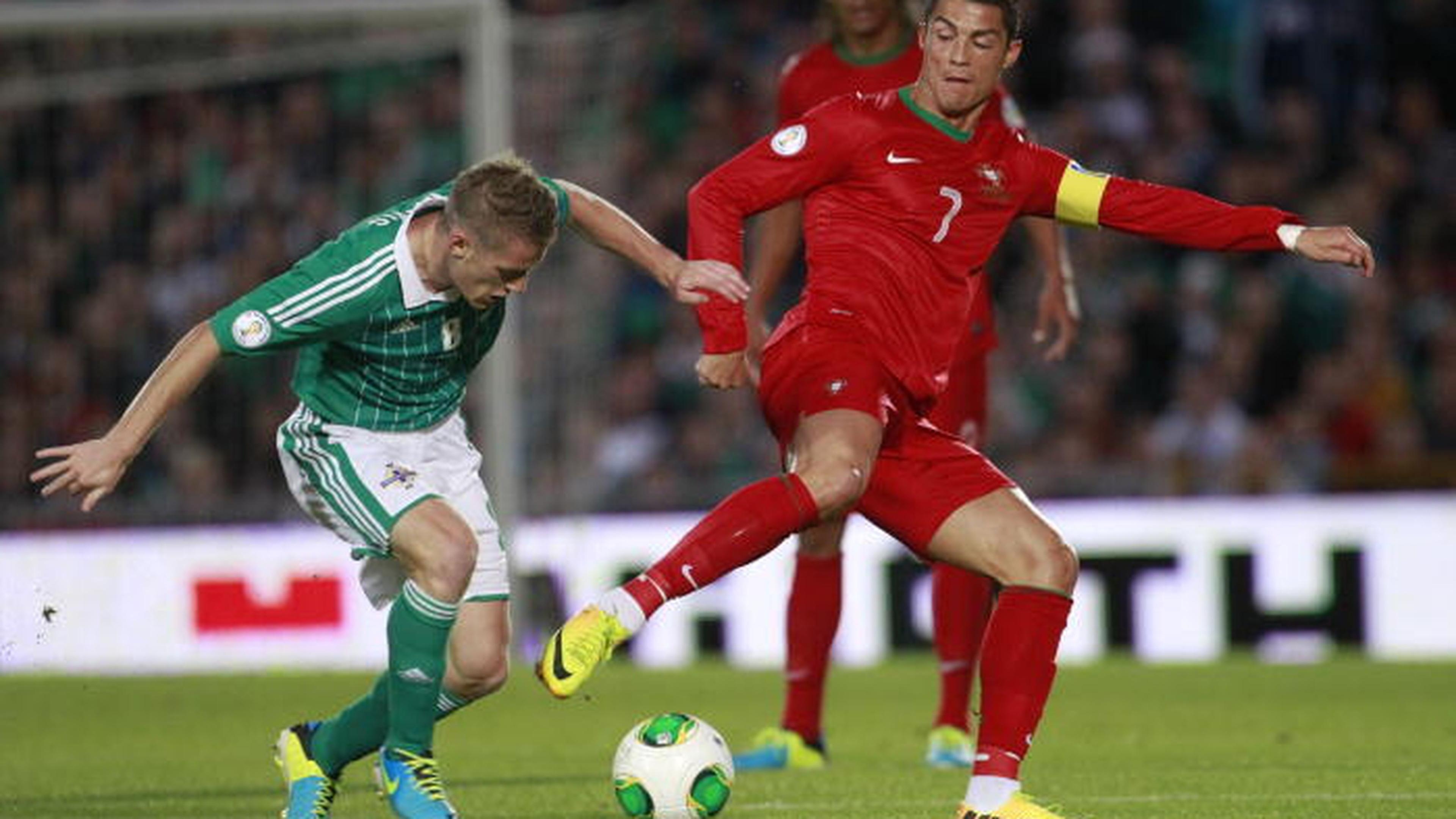 Cristiano Ronaldo marcou três golos esta noite no jogo contra a Irlanda. Aqui numa disputa de bola com Steven Davis da selecção da Irlanda do Norte
