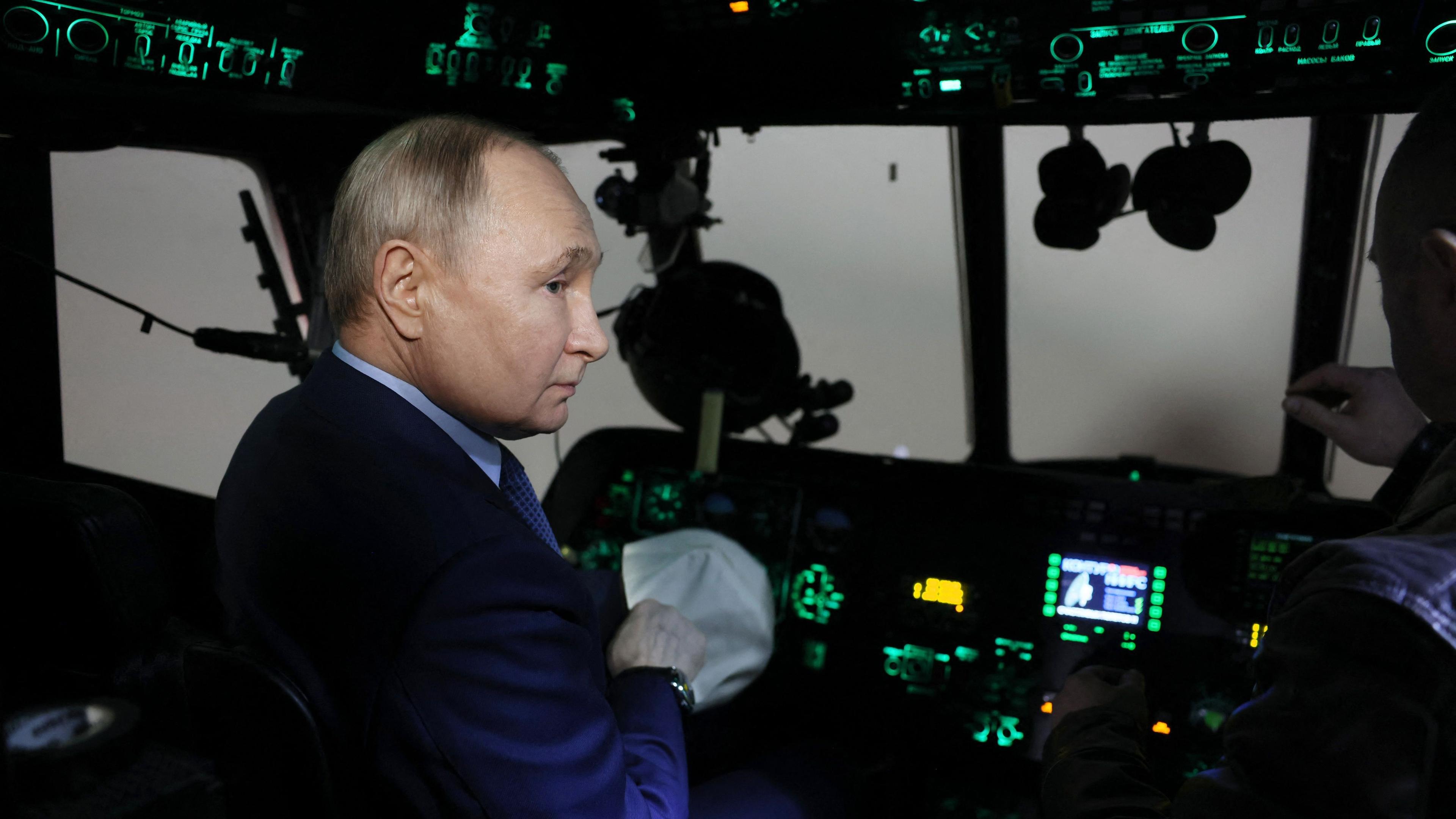 In this pool photograph distributed by the Russian state agency Sputnik, Russia's President Vladimir Putin visits the 344th Army Aviation Centre of aircrews combat training and transition in Torzhok in the Tver region on March 27, 2024. (Photo by Mikhail METZEL / POOL / AFP)