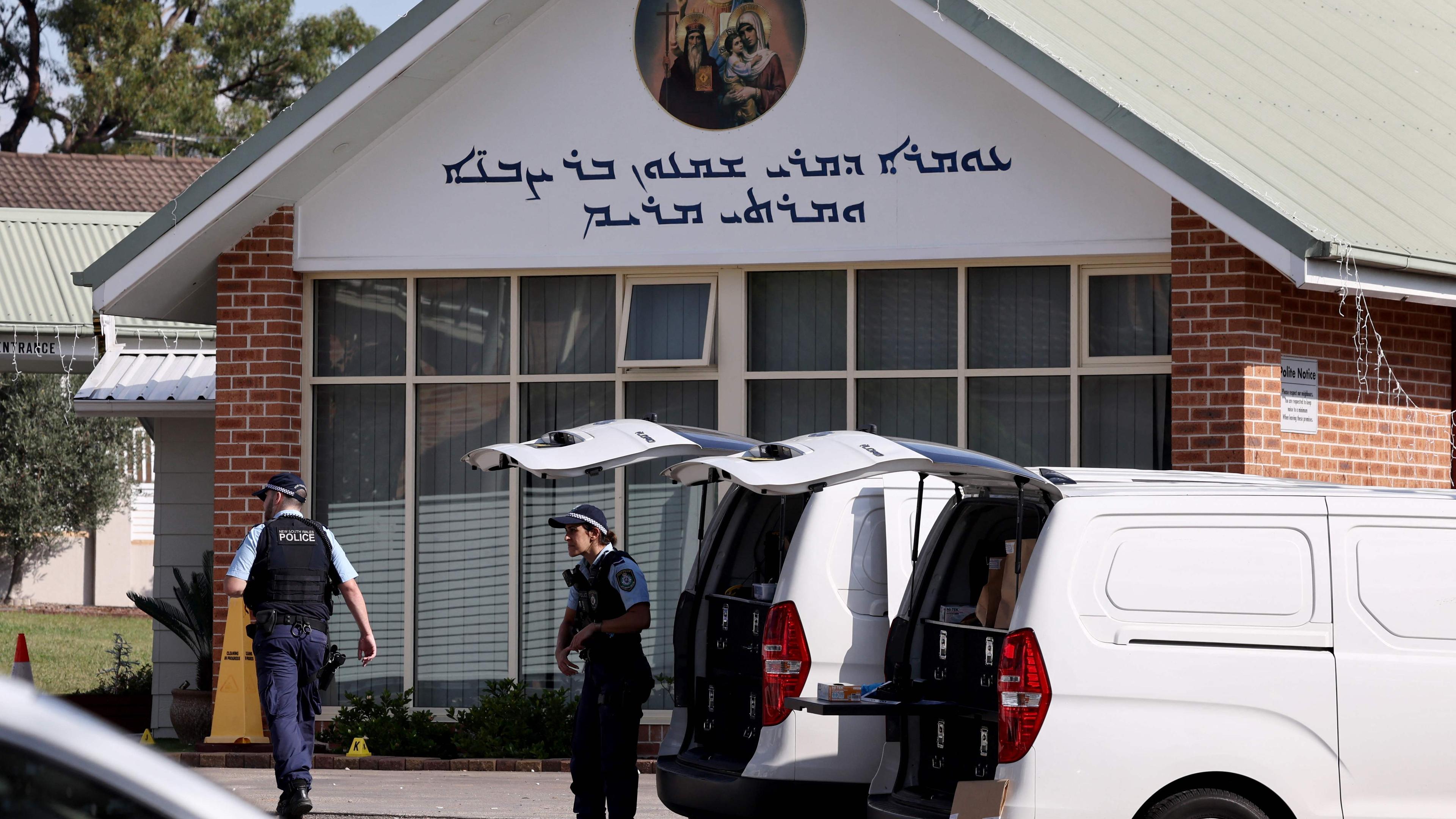 Police officers and their vehicles can be seen outside the Christ the Good Shepherd Church in Sydney's western suburb of Wakeley on April 16, 2024. Australian police on April 16 said a brutal knife attack during a live-streamed church service was a religiously motivated "terrorist" act, as they urged calm from the angered local community. (Photo by DAVID GRAY / AFP)