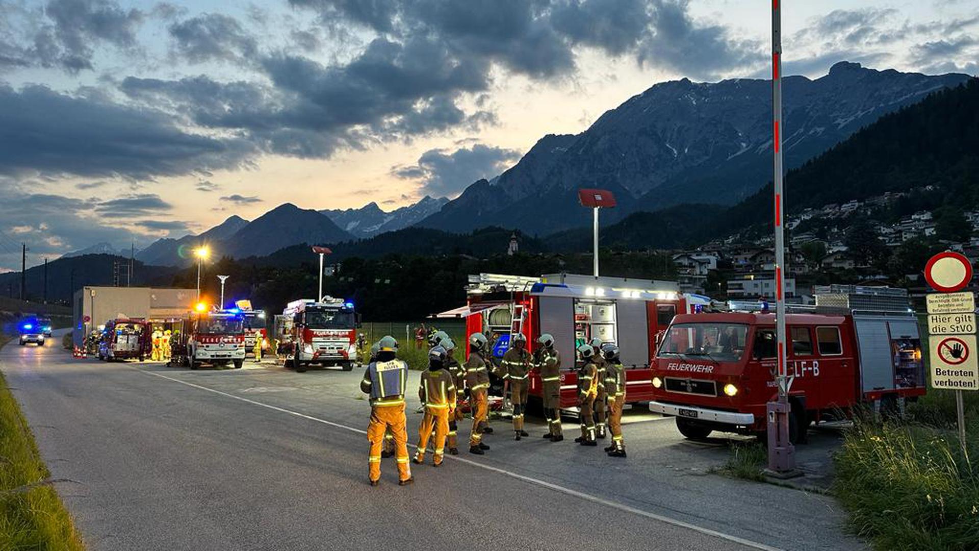 Members of the fire brigade are seen near the Terfener tunnel in Fritzens, western Austria, where a fire broke out for unknown reasons on June 7, 2023. A Nightjet train with about 200 passengers on board was in the tunnel at the time the fire broke out. No casualties were reported so far. (Photo by ZOOM.TIROL / APA / AFP) / Austria OUT